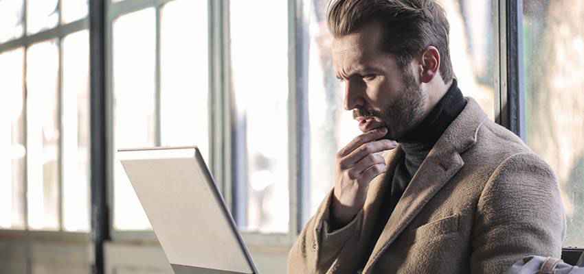 Man looking at a laptop computer.