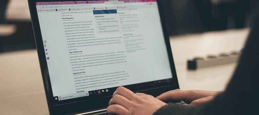 A person typing on a laptop computer.