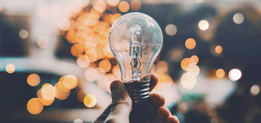 A person holding a lightbulb.